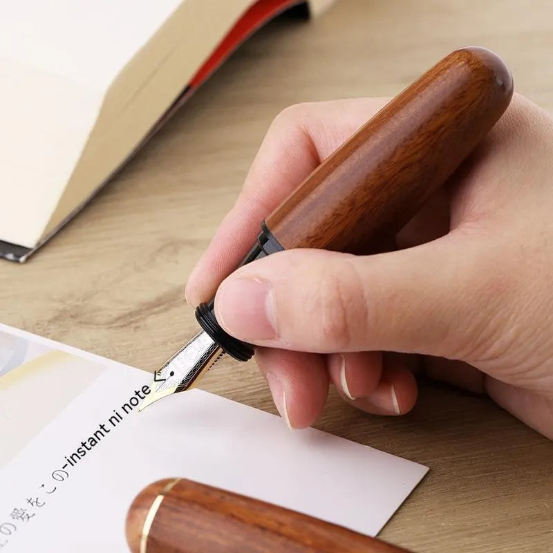 Solid wood short chubby ink pen with fine tip on wooden surface