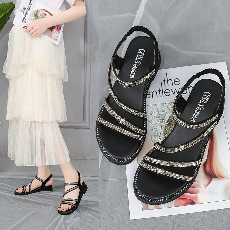 Gold and silver women's flat sandals with round toe, rhinestone details, elastic band, and rubber sole.