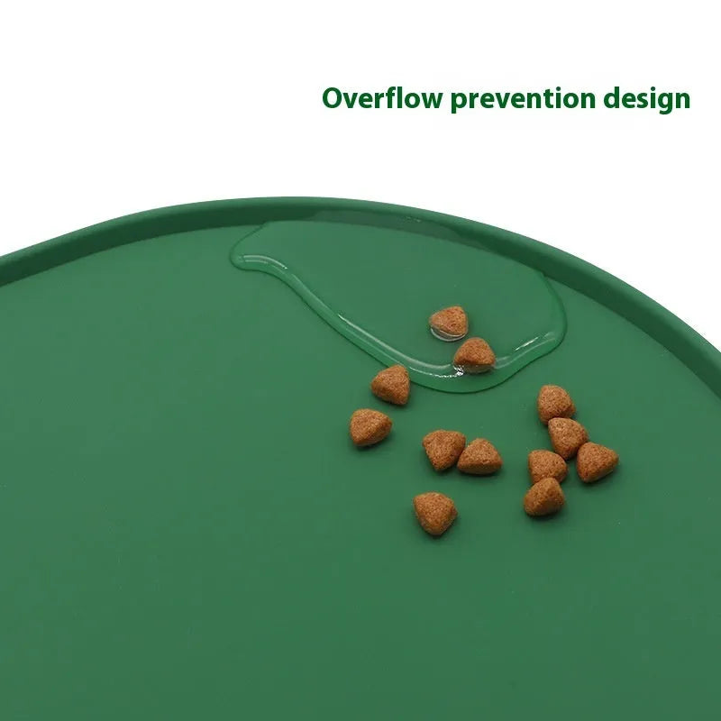 Green silicone waterproof placemat for cat food and water bowls on a floor.