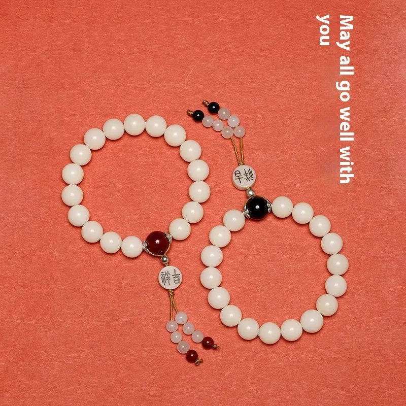 White jade Bodhi bracelet with round 10mm beads, ruyi decoration, shown in obsidian, red agate and red code brain colour variants