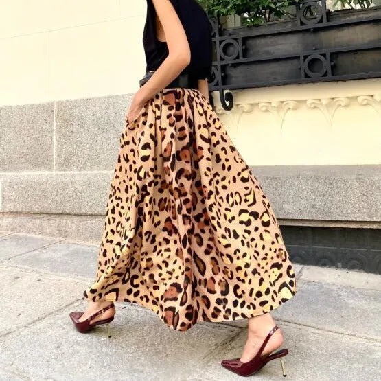 Brown leopard print women's A-line long skirt with a big hem on a model.