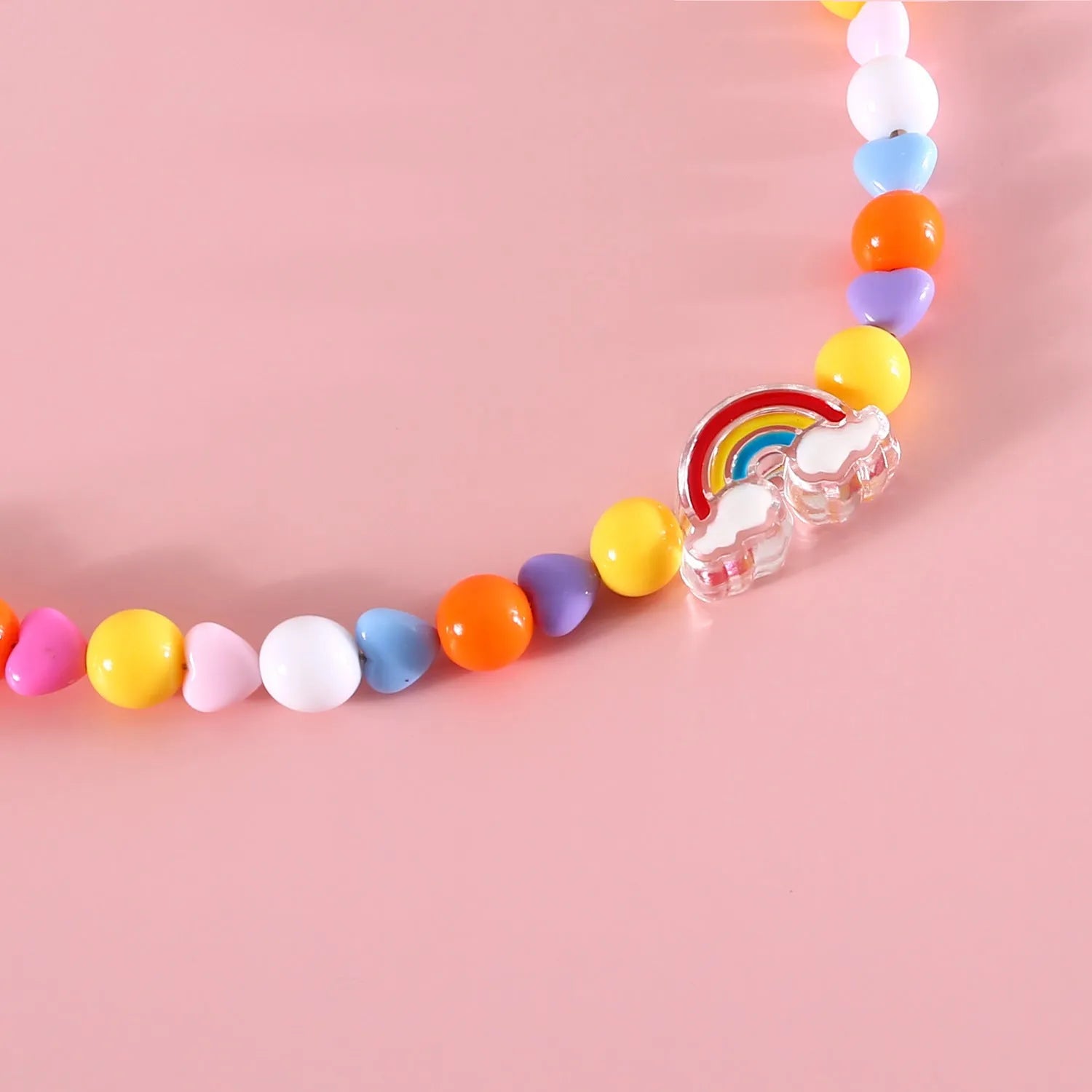 Colourful plastic bead cat necklace showing small flower, rainbow, and peach pattern options with adjustable sizing