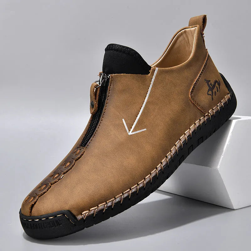 Men's brown zip-up Martin boots with round toe and hand-stitched rubber sole on a neutral background.
