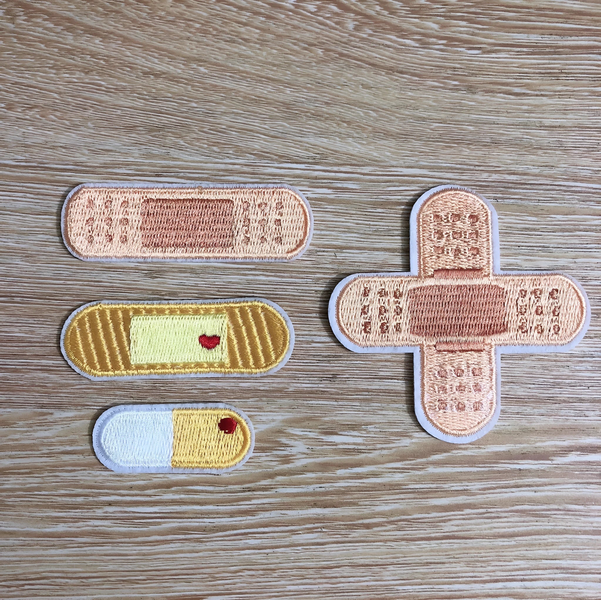 Ten computer embroidered patch badges with full embroidery and lace craft detailing for clothing customisation