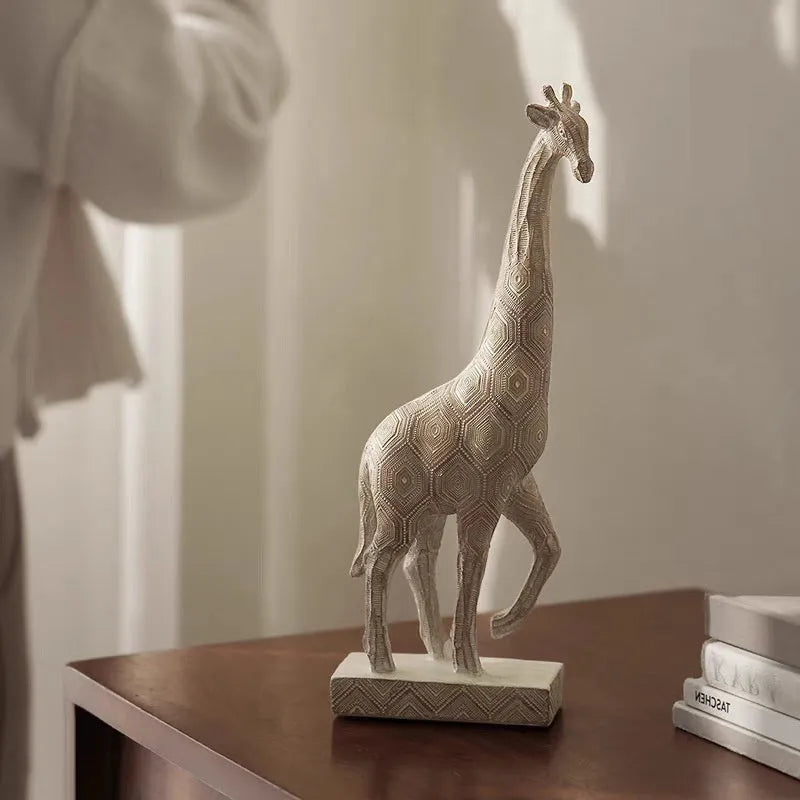 Tall wooden-coloured giraffe resin figurine ornament on a surface.