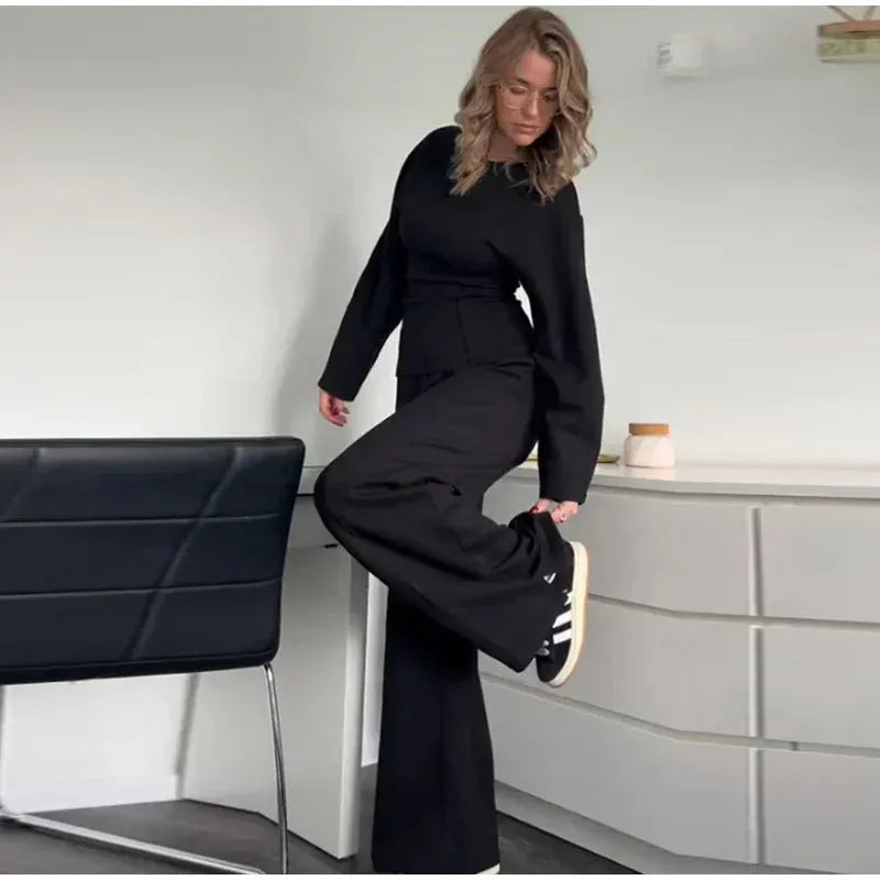 Women's black polar fleece suit set with long sleeve pleated top and wide leg trousers