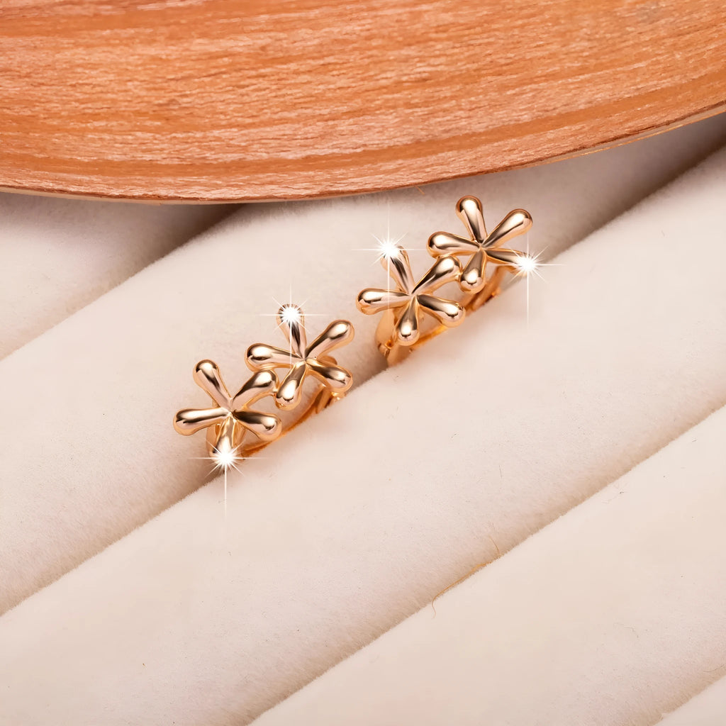 A pair of rose gold coloured waterdrop and circular shaped women's earrings on a white background.