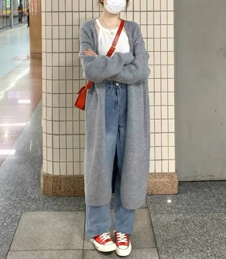 Women's loose fit grey knitted V-neck cardigan coat with long sleeves, shown mid-length.