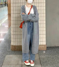 Women's loose fit grey knitted V-neck cardigan coat with long sleeves, shown mid-length.