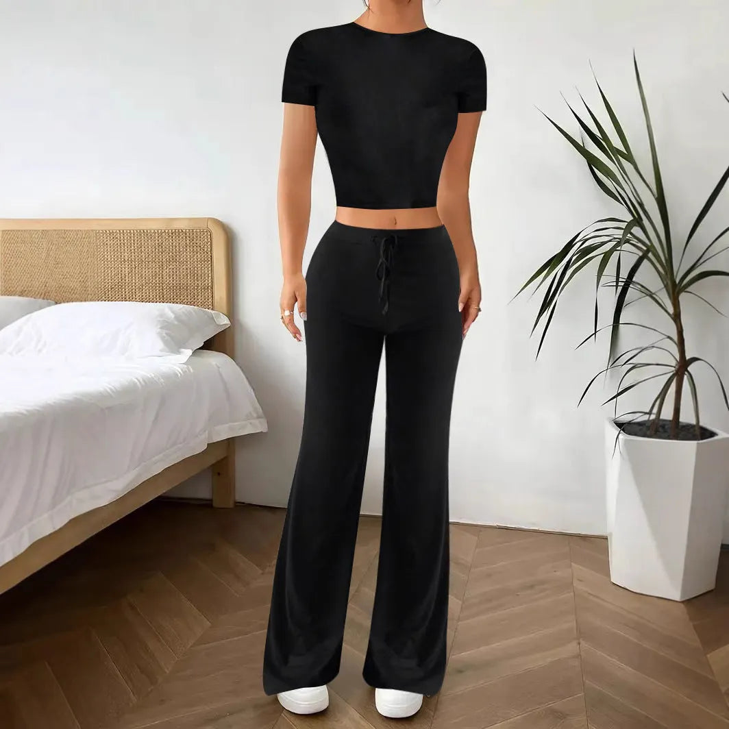 Black high-waist trousers and matching short-sleeve t-shirt set on a hanger.