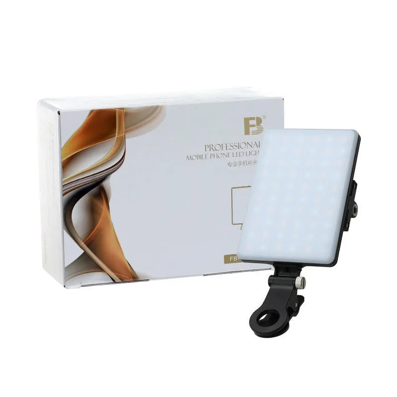 White portable LED fill light clipped to mobile phone with adjustment knob visible