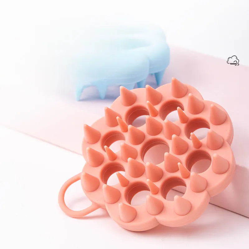 Blue silicone pet grooming brush with flexible massage bristles for wet or dry use on cats and dogs.