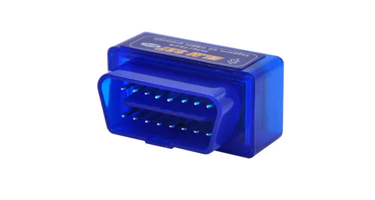 Small black Bluetooth OBD2 car diagnostic scanner next to a vehicle's diagnostic port