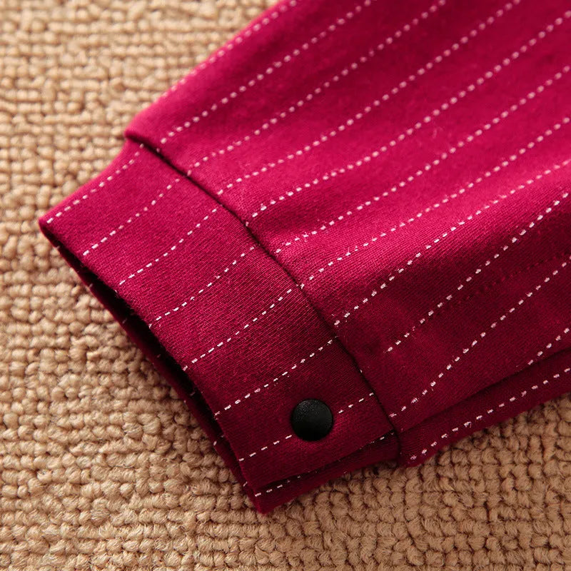 Baby boy wearing a wine red long-sleeved gentleman-style cotton jumpsuit with single-breasted closure.