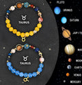 Two natural stone and glass beaded bracelets with zodiac sign designs on a flat surface