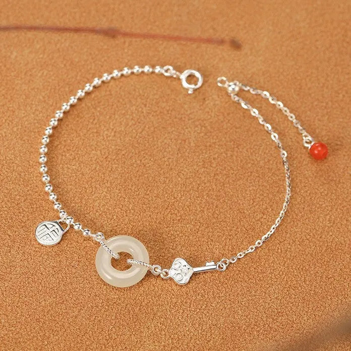 Silver Hetian jade bracelet with peace buckle charm and Chinese Ruyi Xiaofu design for women