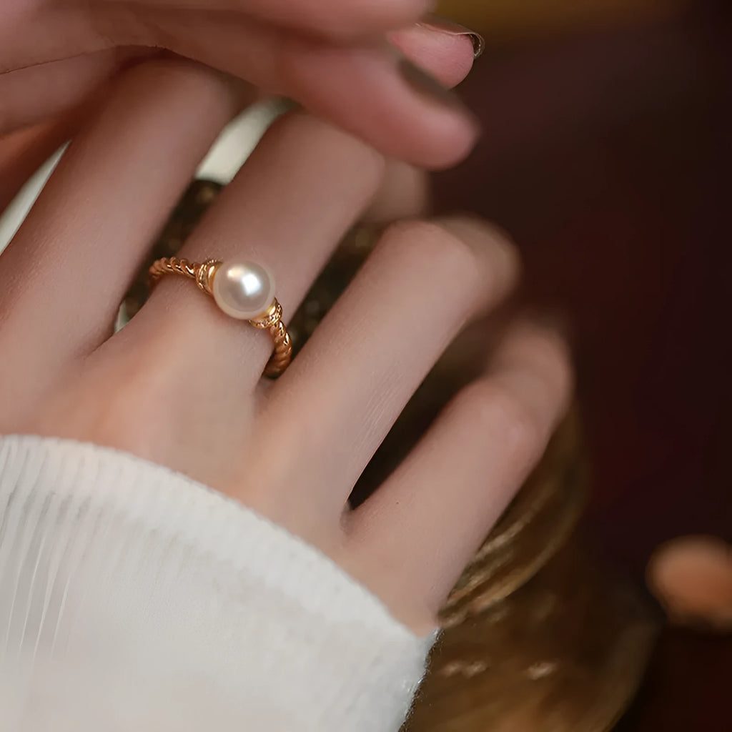 Adjustable antique twist copper ring with a geometric pearl centre in gold and silver colours.