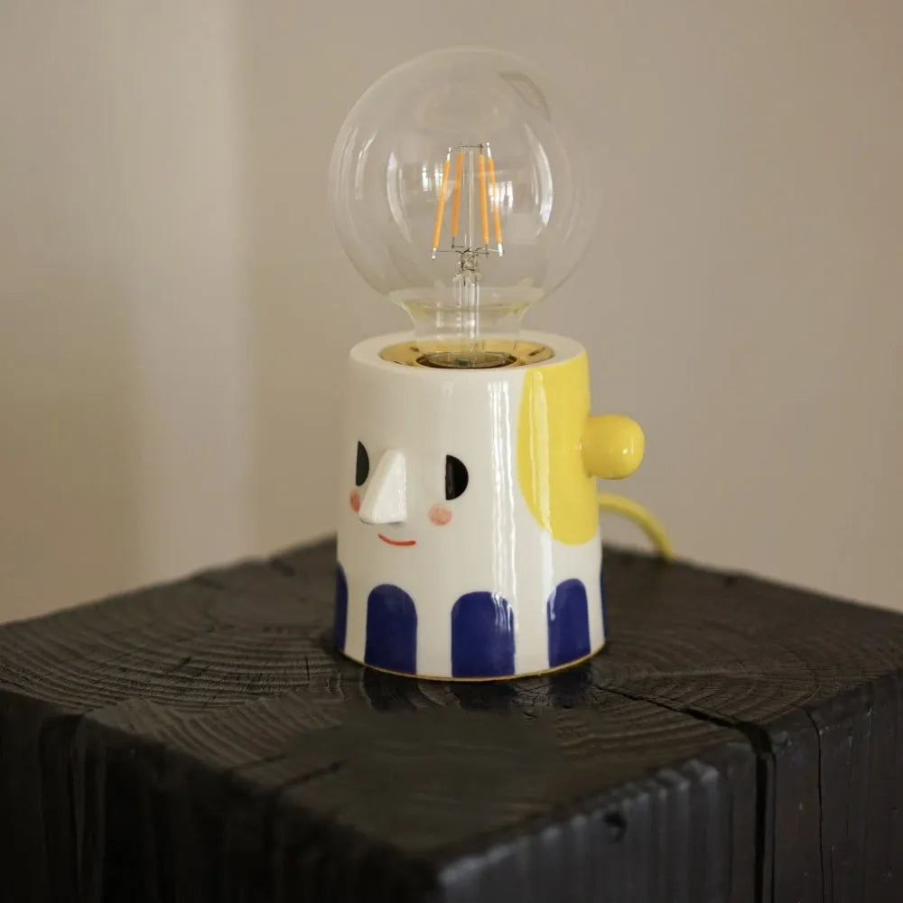 Handmade ceramic table lamp with a spherical ball headlight design on a solid ceramic base.