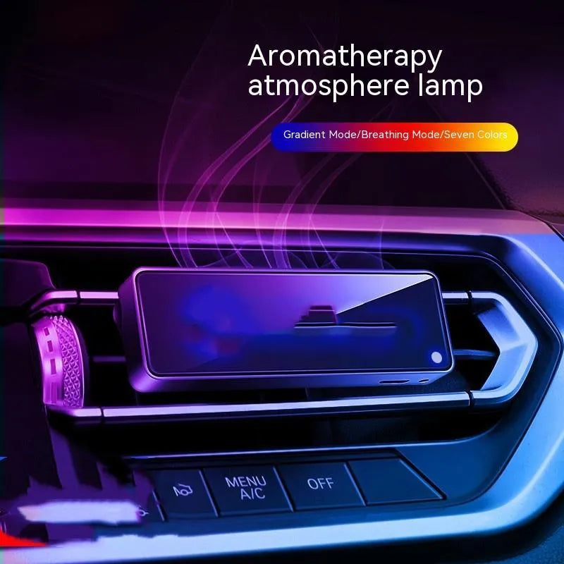 Black car air vent perfume diffuser with LED light attached to dashboard vent