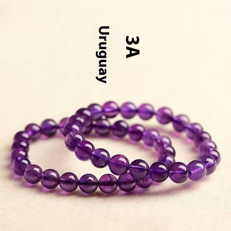 Natural Uruguay amethyst scattered bead bracelet showing purple gemstone beads on a string.