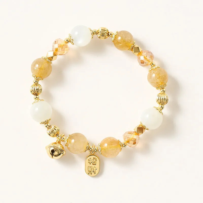 Korean style gold bracelet with rutilated quartz crystal charms on an electroplated chain.
