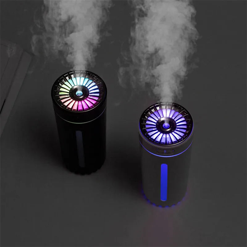 Black portable USB humidifier with colourful lights on a car cup holder.