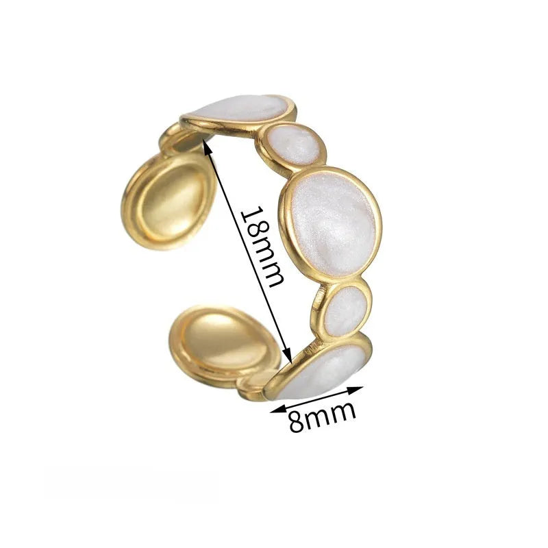 Silver geometric ring with an adjustable opening on a plain background
