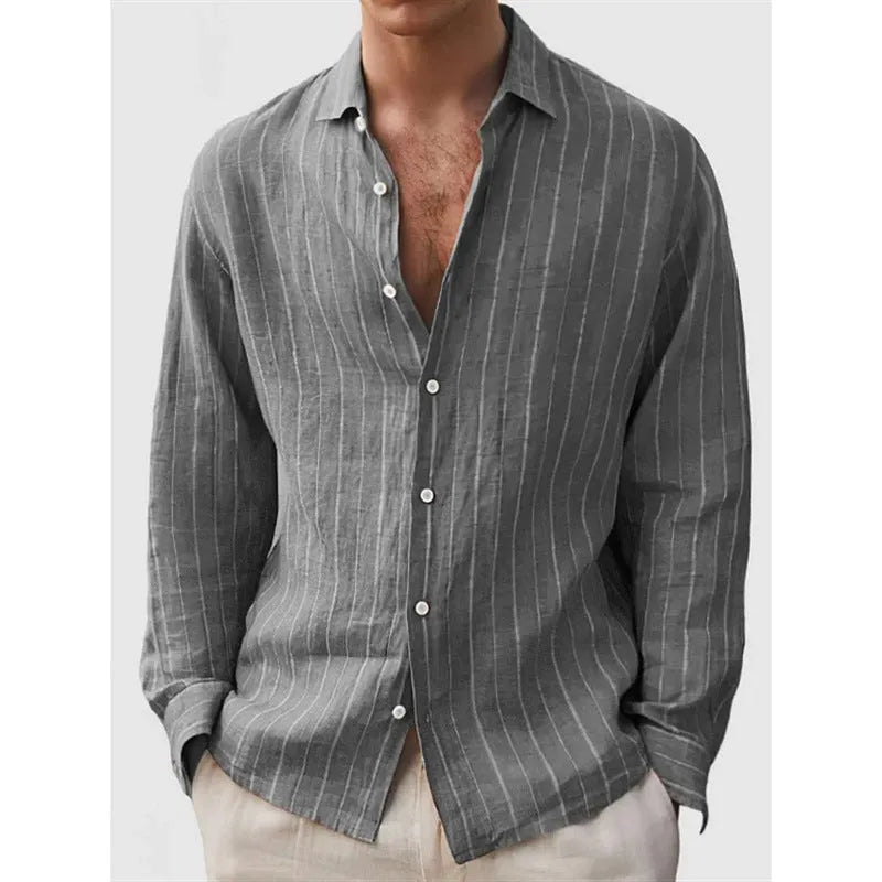 Man wearing a loose fit, short sleeve, striped cardigan shirt in a casual setting.