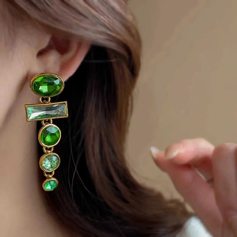A pair of green gradient retro earrings with a geometric shape, tassel detail, and zircon inlay on an alloy base.