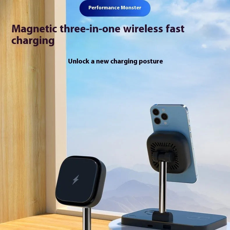 Black magnetic three-in-one wireless charger and cooling bracket on a desk, with phone upright and watch on base.