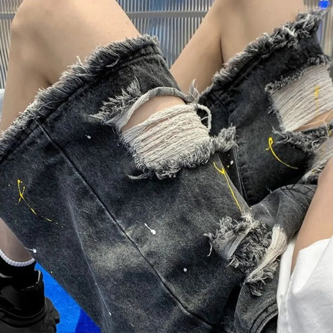 Men's loose fit light blue denim shorts with water washed hole design and fifth pants length.