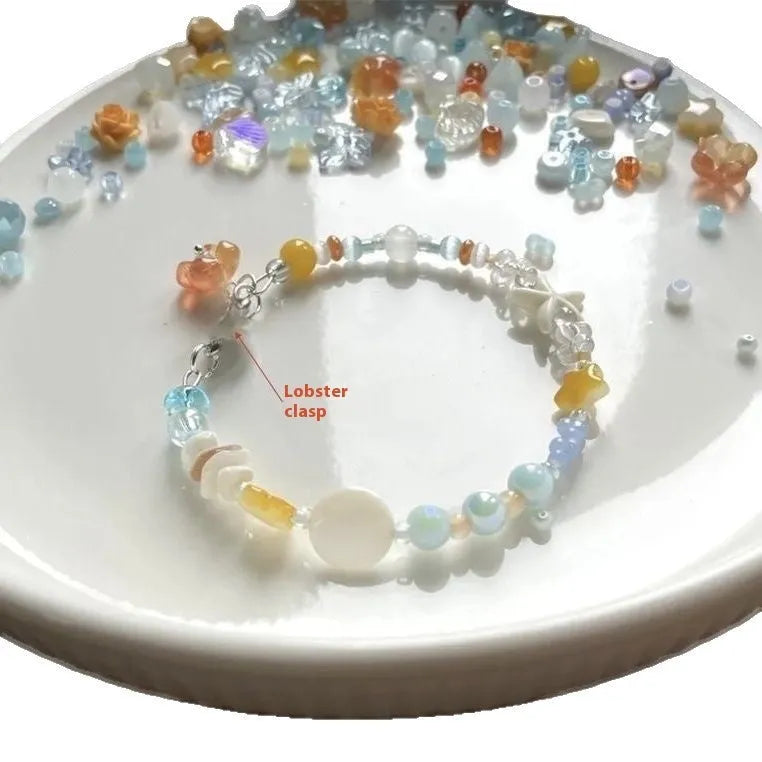 Orange women's bracelet with diamond links and round decorative elements on wrist