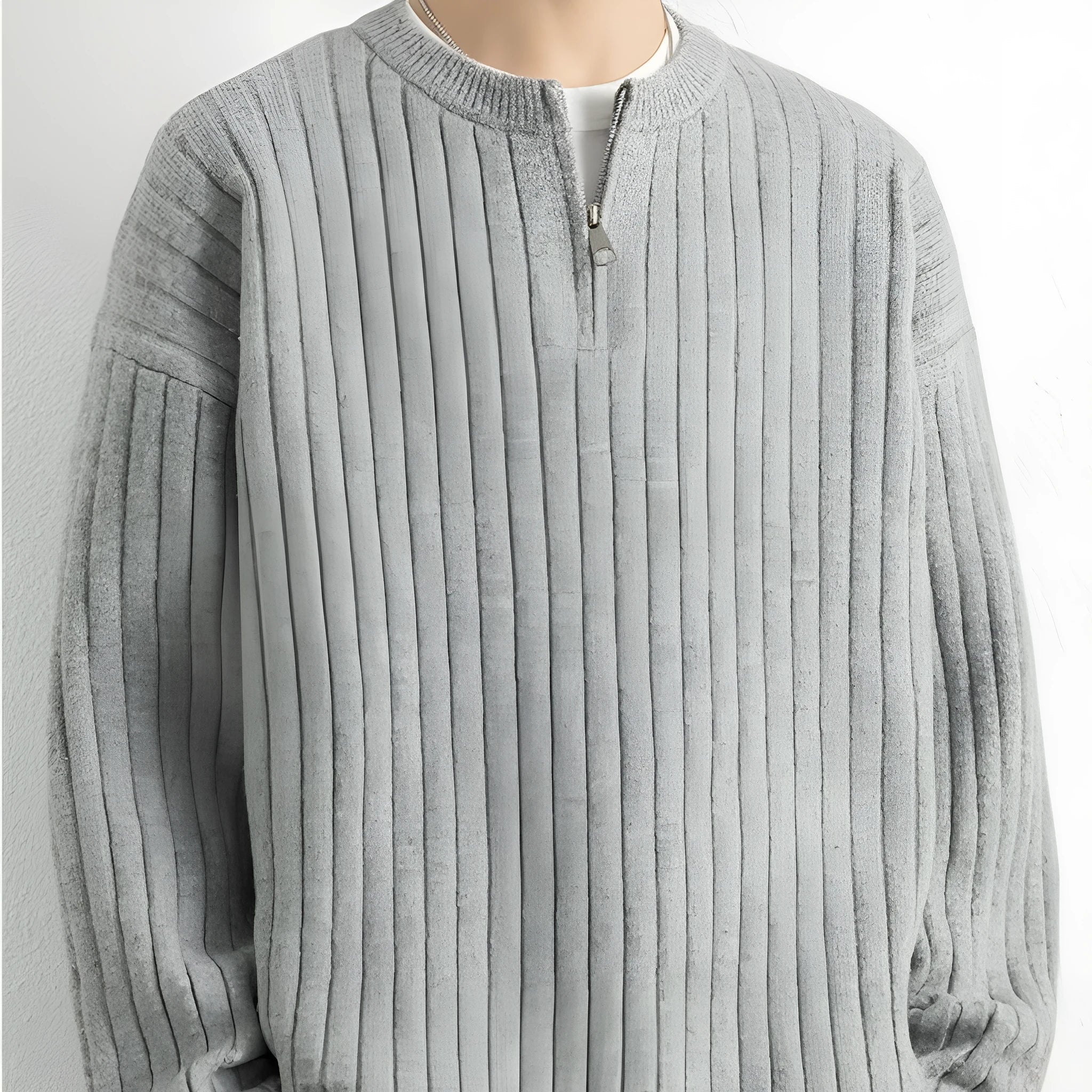 A grey men's loose-fit half-zip sweater with a textured knit and long sleeves.