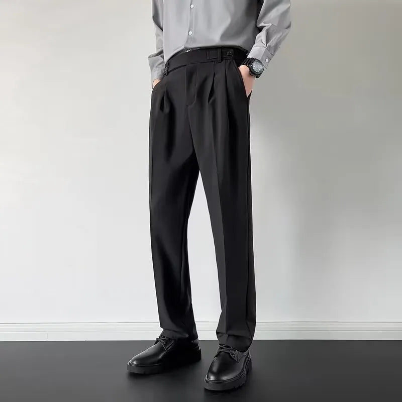 Man wearing straight-loose fit suit trousers in apricot colour, showcasing the leg cut and formal style.