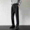 Man wearing straight-loose fit suit trousers in apricot colour, showcasing the leg cut and formal style.