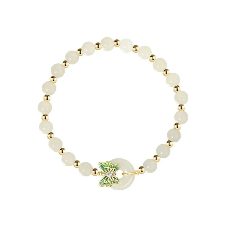Cyan Hetian jade bracelet with a detailed sterling silver butterfly and gemstone ornament.