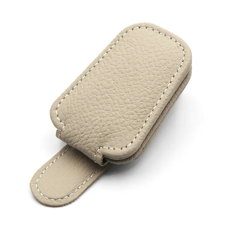 Car sunglasses clip holder made from PU leather in various colours, clipped to a sun visor.
