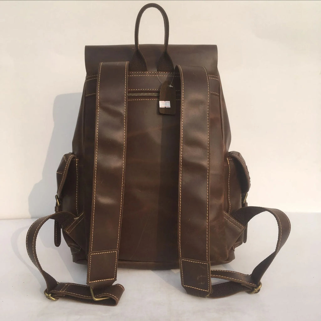 Brown men's leather backpack with an air-pillow belt system on the back.
