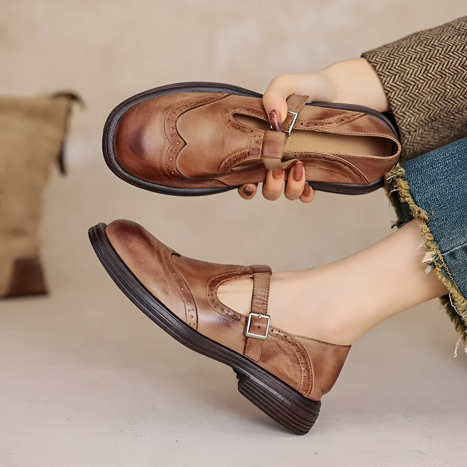 Women's black British style leather flat shoe with round toe and slip-on design on a neutral background.