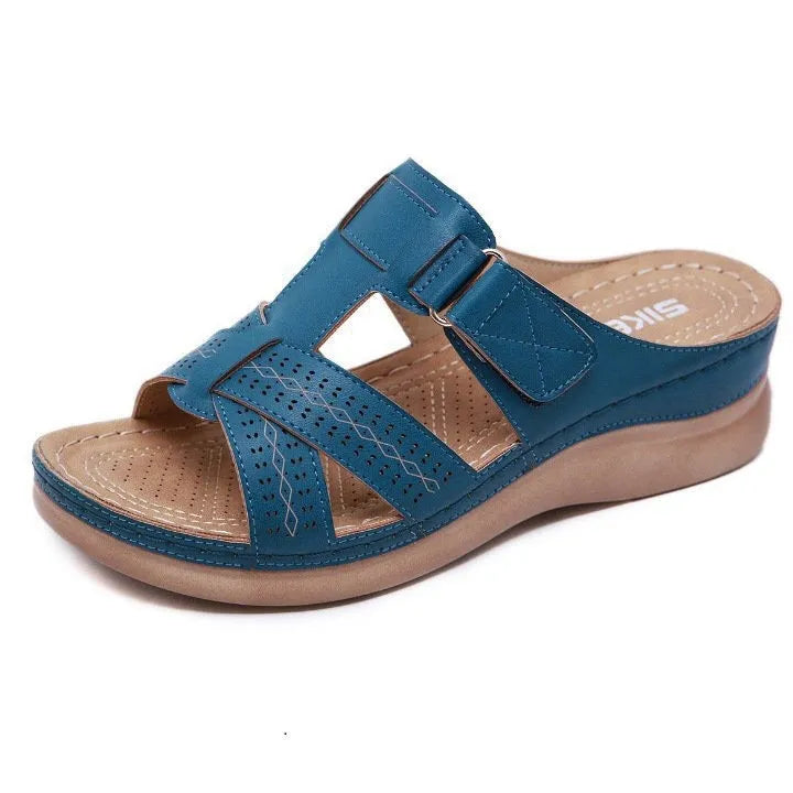 Women's black wedge sandals with a peep toe and Velcro fastening strap on a white background.