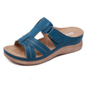 Women's black wedge sandals with a peep toe and Velcro fastening strap on a white background.