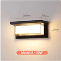 Waterproof IP65-rated outdoor wall lamp with aluminium body and acrylic shade, shown in a garden setting.
