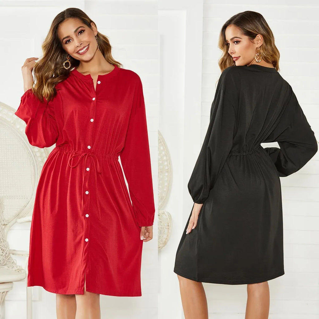 Women's black A-line midi dress with long sleeves, elastic cuffs, and a cinched elastic waist belt.