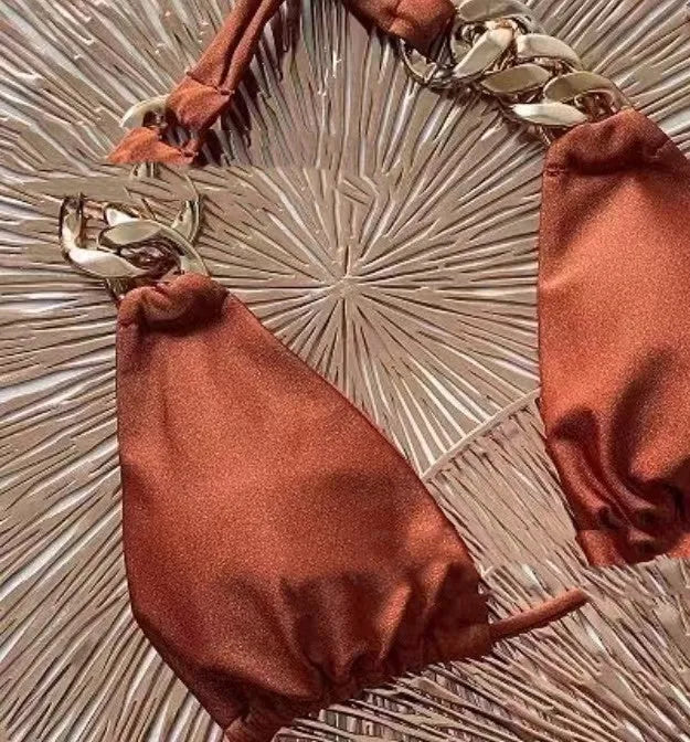 Brown women's tube-top push-up bikini with ring tether detailing on a solid background.