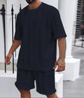 Men's knitted jacquard short sleeve pullover and shorts set in a solid colour on a hanger.