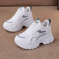 White women's lace-up dad shoes with cross straps and a breathable mesh upper.
