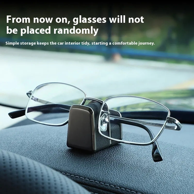 Zinc alloy and leather glasses clip for car dashboard in black, grey, green, or red.