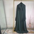 Women's one-piece prayer dress in dark green polyester with regular sleeves and strap details