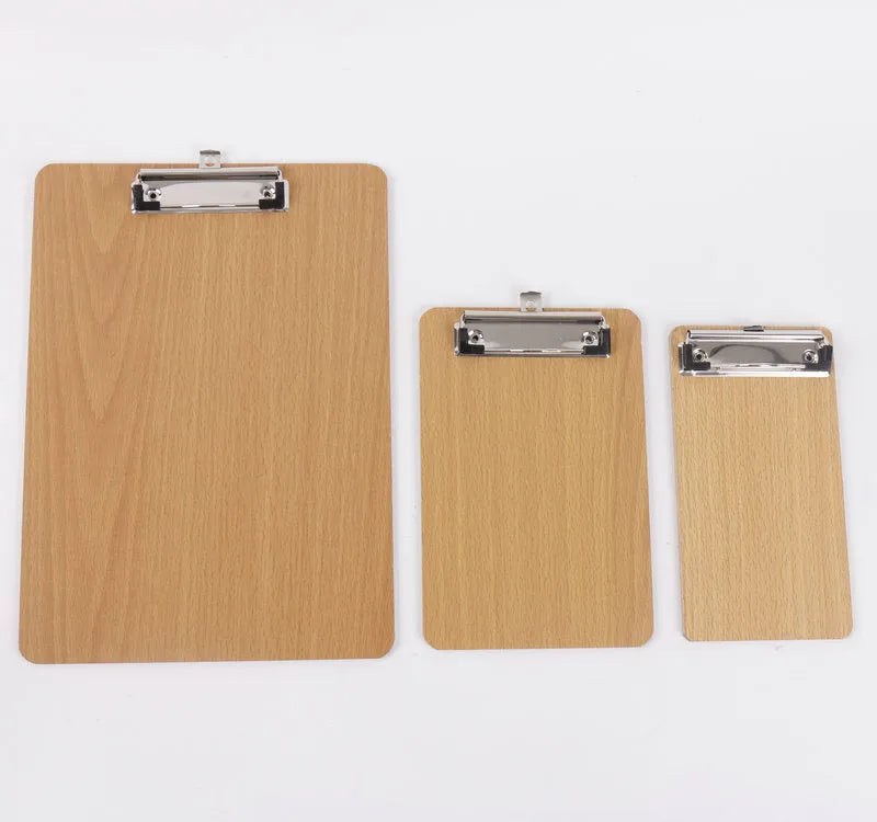 A4 wooden clipboard with metal clip and hanging hole placed on a desk