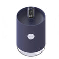 A blue wireless humidifier with a USB cable on a wooden desk.